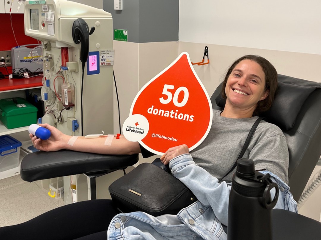 Mads donating blood with Lifeblood, celebrating 50 donations